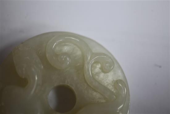 A Chinese white jade bi disc, diameter 4.6cm, wood stand